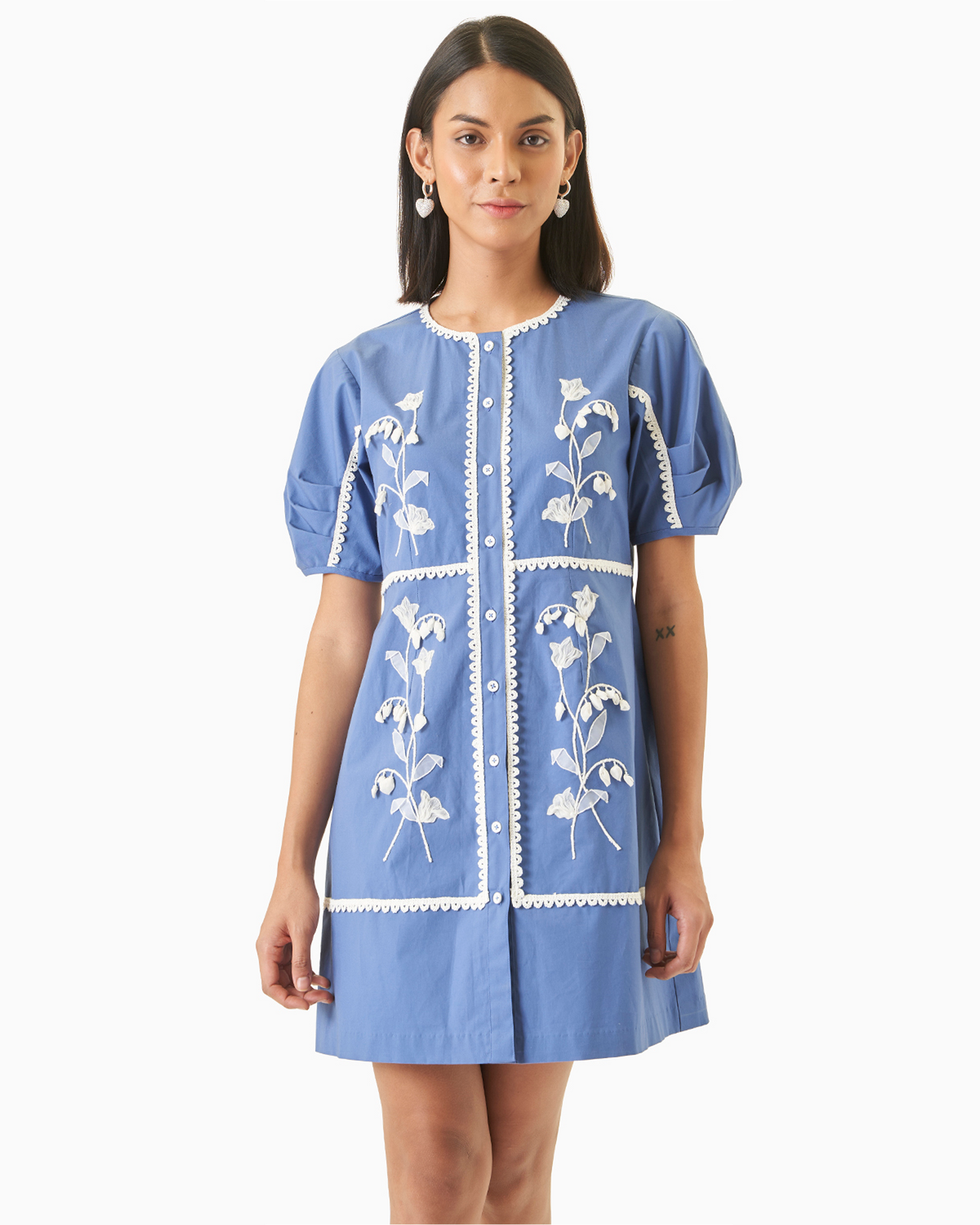 Daffodil Dress - Blue Cotton Dress with white floral embroidery, front buttons, and ruffle sleeves in a straight-fit silhouette.